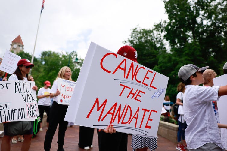 People protest mandates related to COVID-19.