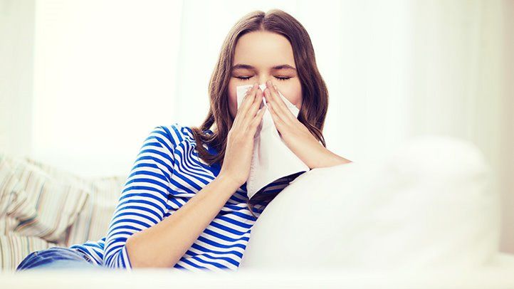 a woman blowing her nose