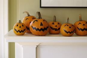 Cover your mantle with friendly pumpkins. Since this kind of jack-o'-lantern involves no carving, kids can tackle it solo. See more Halloween pictures.