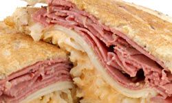 A traditional Reuben is stacked high with corned beef and sauerkraut.